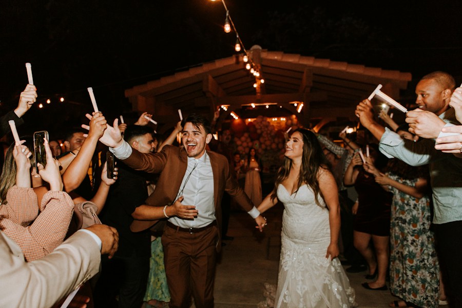 Bride and groom leaving through a sparkler tunnel